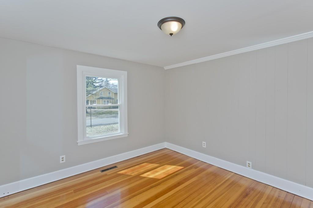 67 Colemore Street Feeding Hills, MA 01030 - Photo 14 of 42 an empty room with wooden floor and windows