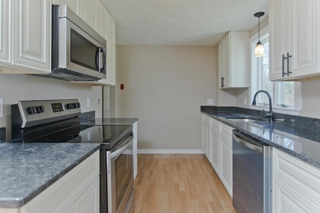 67 Colemore Street Feeding Hills, MA 01030 - Photo 5 of 42 a kitchen with a sink stove and microwave