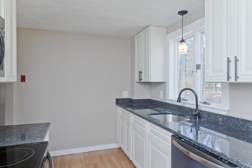 67 Colemore Street Feeding Hills, MA 01030 - Photo 6 of 42 a kitchen with granite countertop a sink cabinets and stainless steel appliances