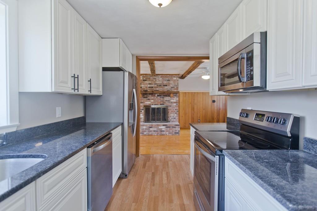 67 Colemore Street Feeding Hills, MA 01030 - Photo 8 of 42 a kitchen with stainless steel appliances granite countertop a stove a sink and a refrigerator