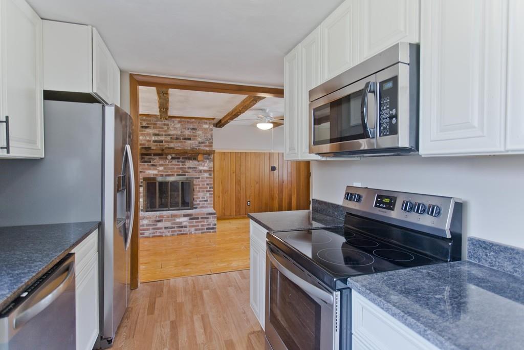 67 Colemore Street Feeding Hills, MA 01030 - Photo 9 of 42 a kitchen with granite countertop a stove and a sink