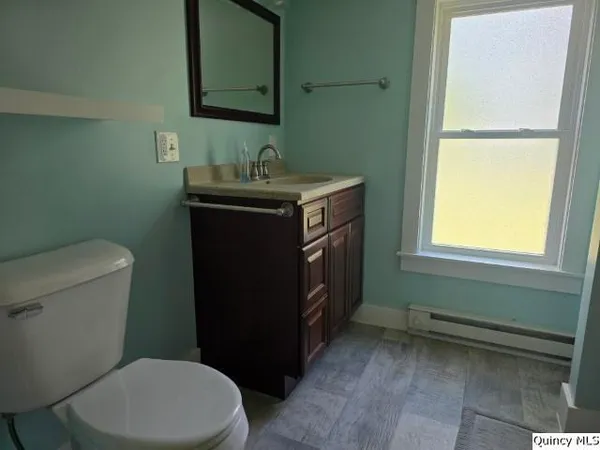 a bathroom with a sink a toilet and a mirror