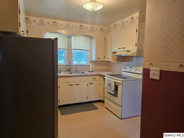 a kitchen with a sink dishwasher a stove and a refrigerator