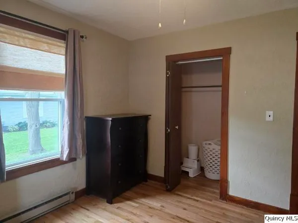 a area with wooden floor and a bathroom