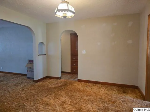a view of a livingroom with a ceiling fan and window