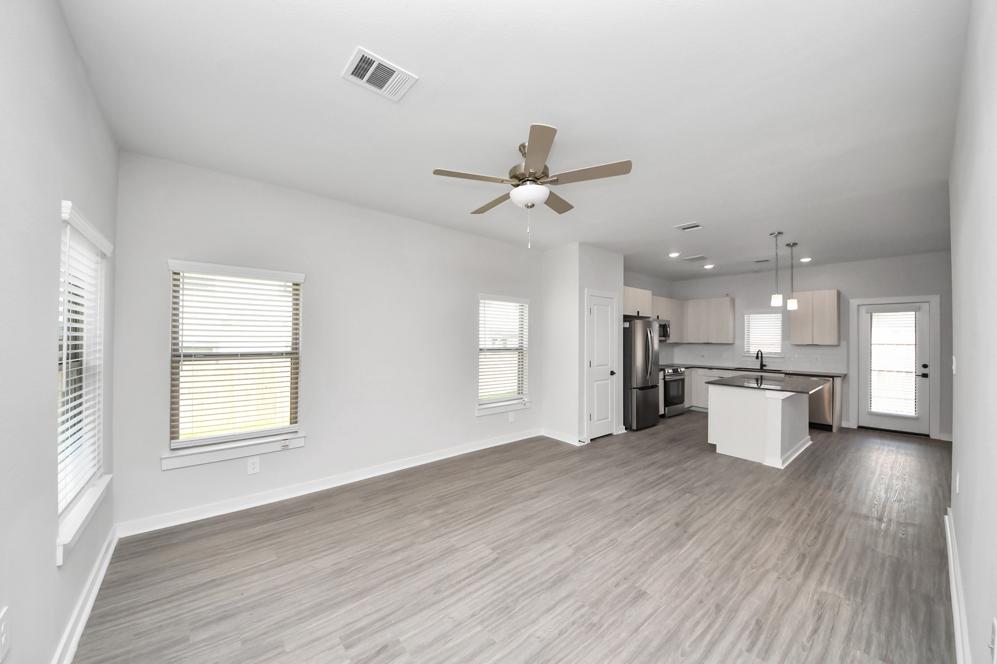 7711 Longmire Road, Unit 32 Conroe, TX 77304 - Photo 43 of 48 Boasting luxury finishes-stylish Island kitchen,granite counters,subway tile backsplash,ample custom cabinet space,stainless appliances,refrigerator,full size washer&dryer included,wood-like flooring throughout,open concept floor plan.