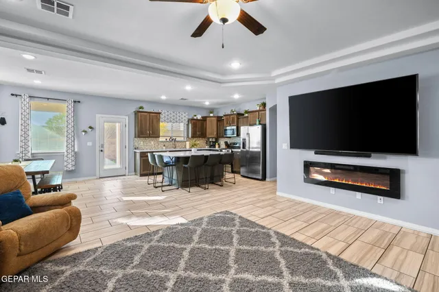a kitchen with a dining table chairs refrigerator and cabinets