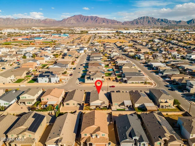 a kitchen with a table chairs sink and cabinets