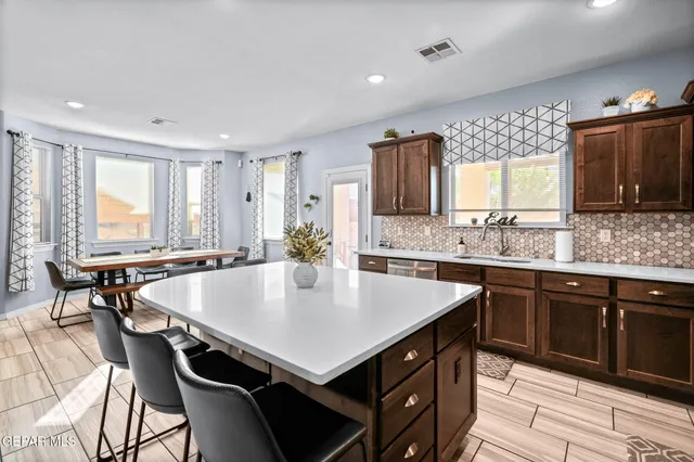 a kitchen with a table chairs and a refrigerator