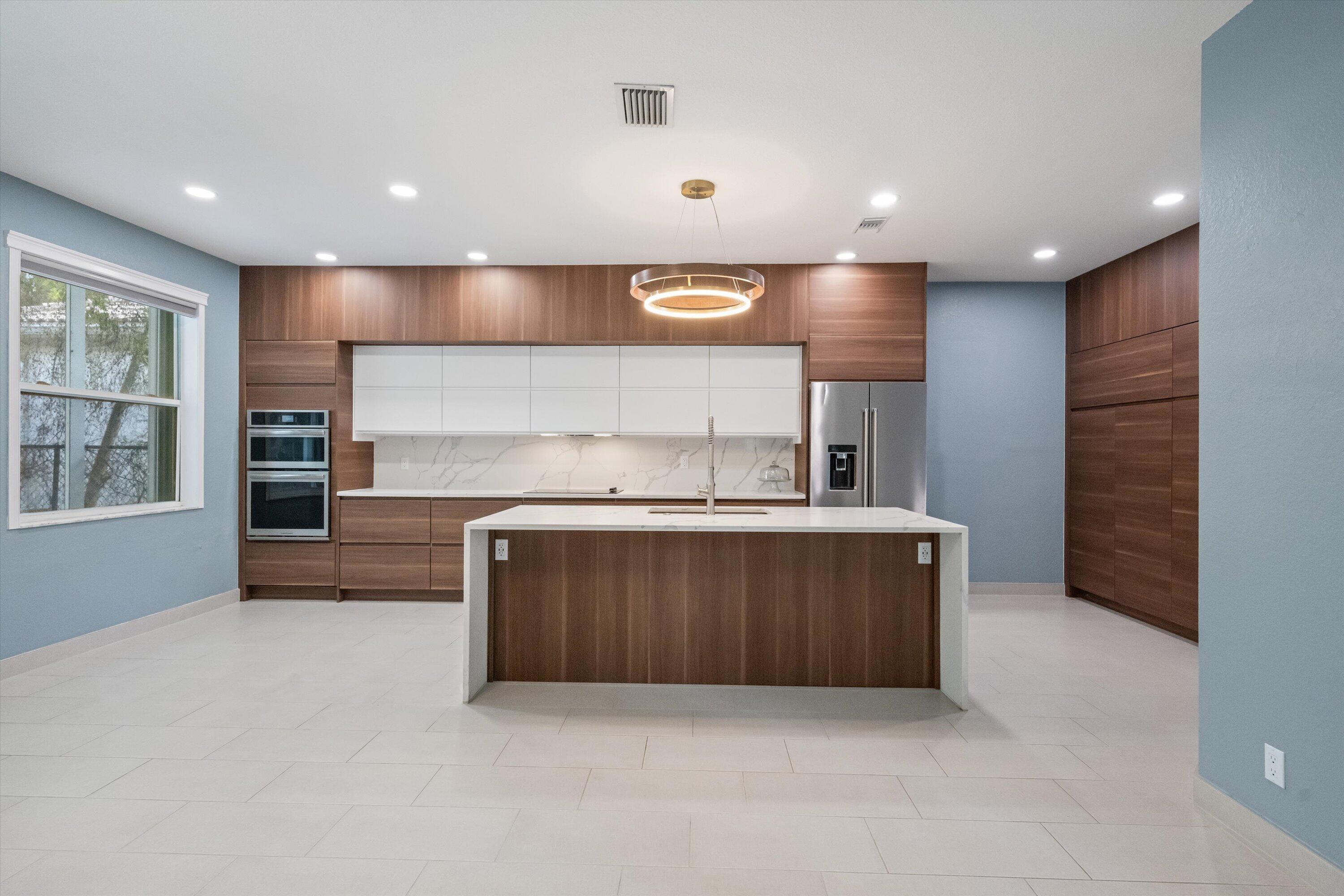 1222 Rose Gate Boulevard Riviera Beach, FL 33404 - Photo 1 of 29 a kitchen with a refrigerator and a sink