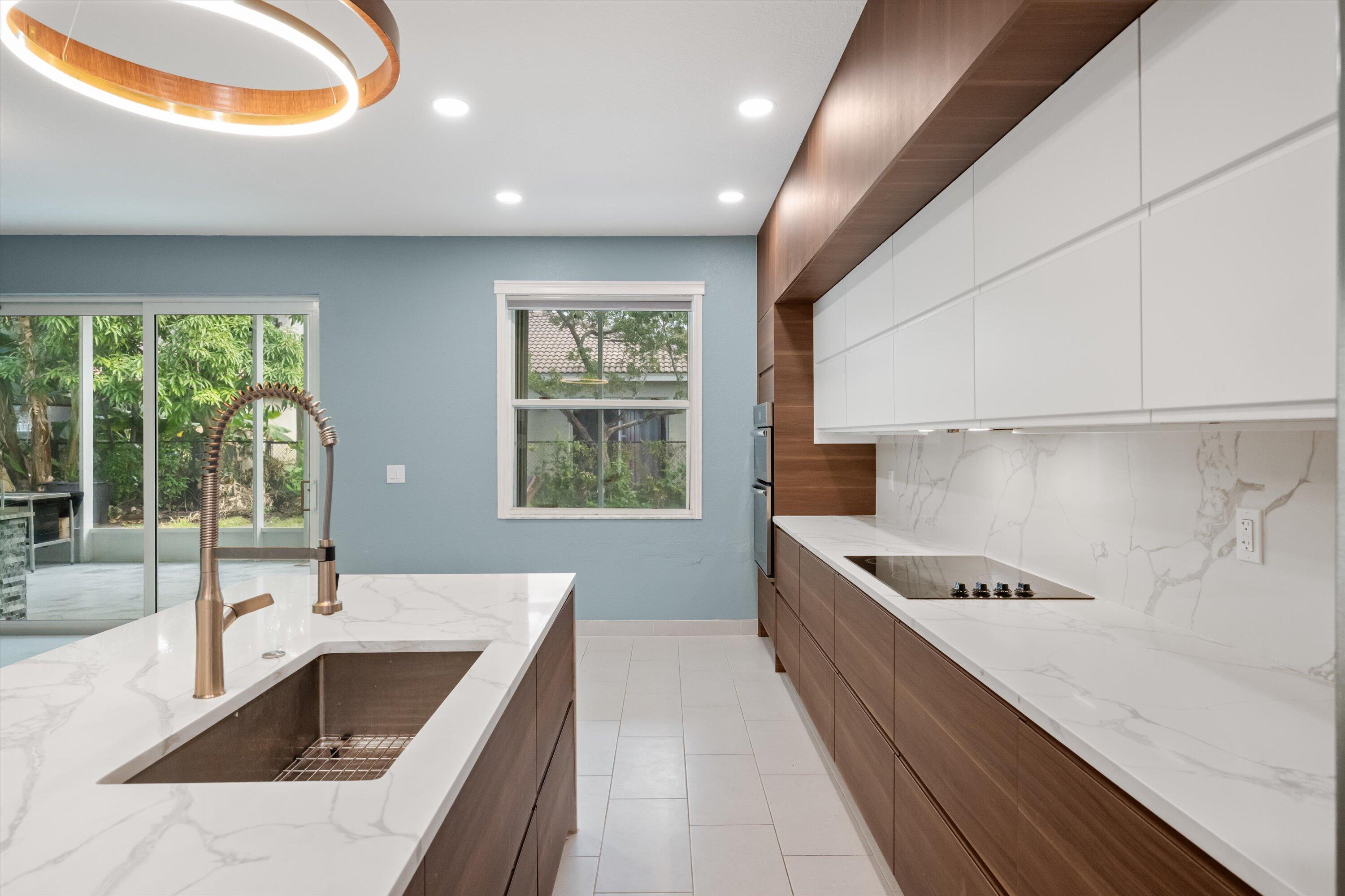 1222 Rose Gate Boulevard Riviera Beach, FL 33404 - Photo 11 of 29 a kitchen with stainless steel appliances granite countertop a sink and a stove
