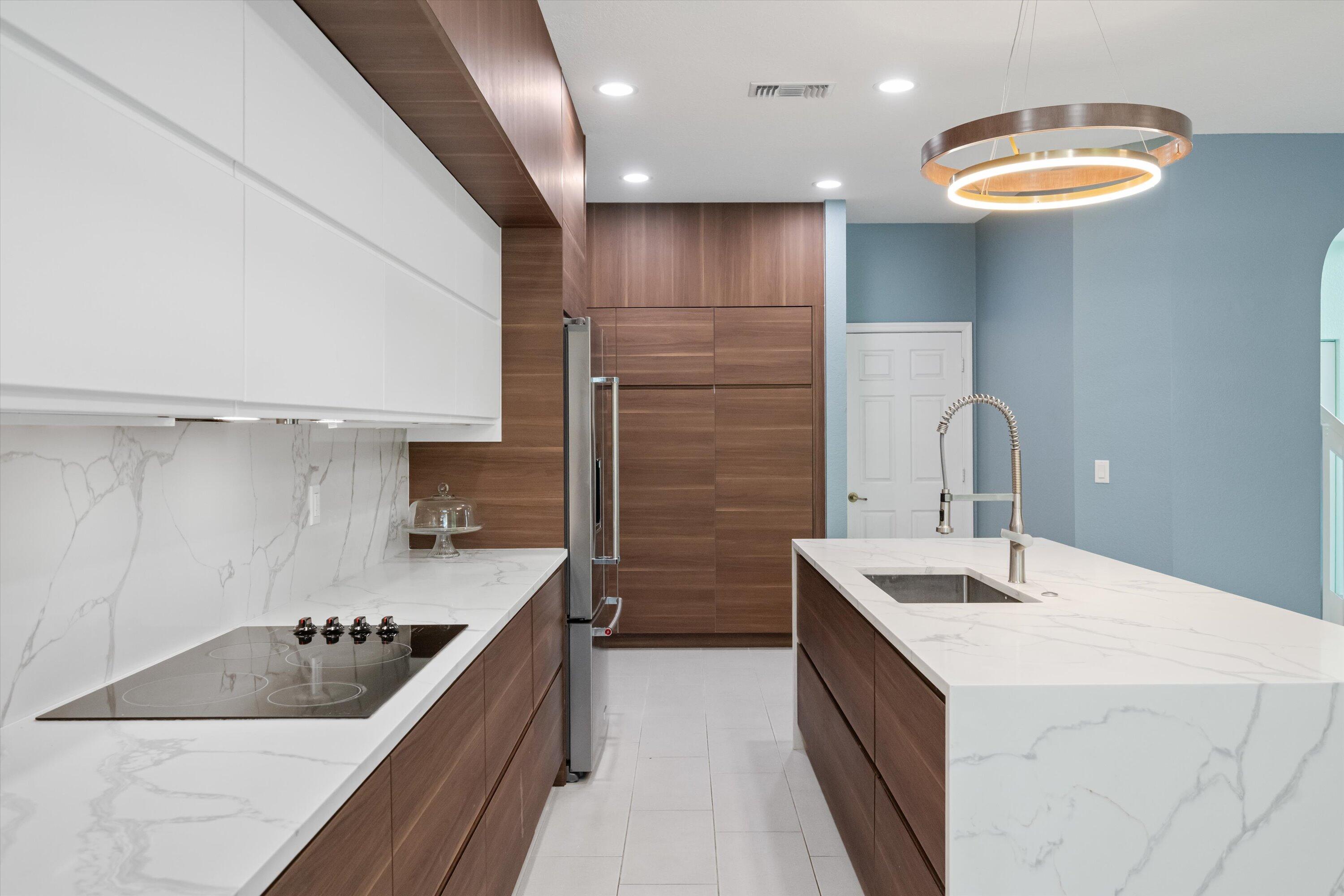 1222 Rose Gate Boulevard Riviera Beach, FL 33404 - Photo 12 of 29 a kitchen with a sink stove and refrigerator