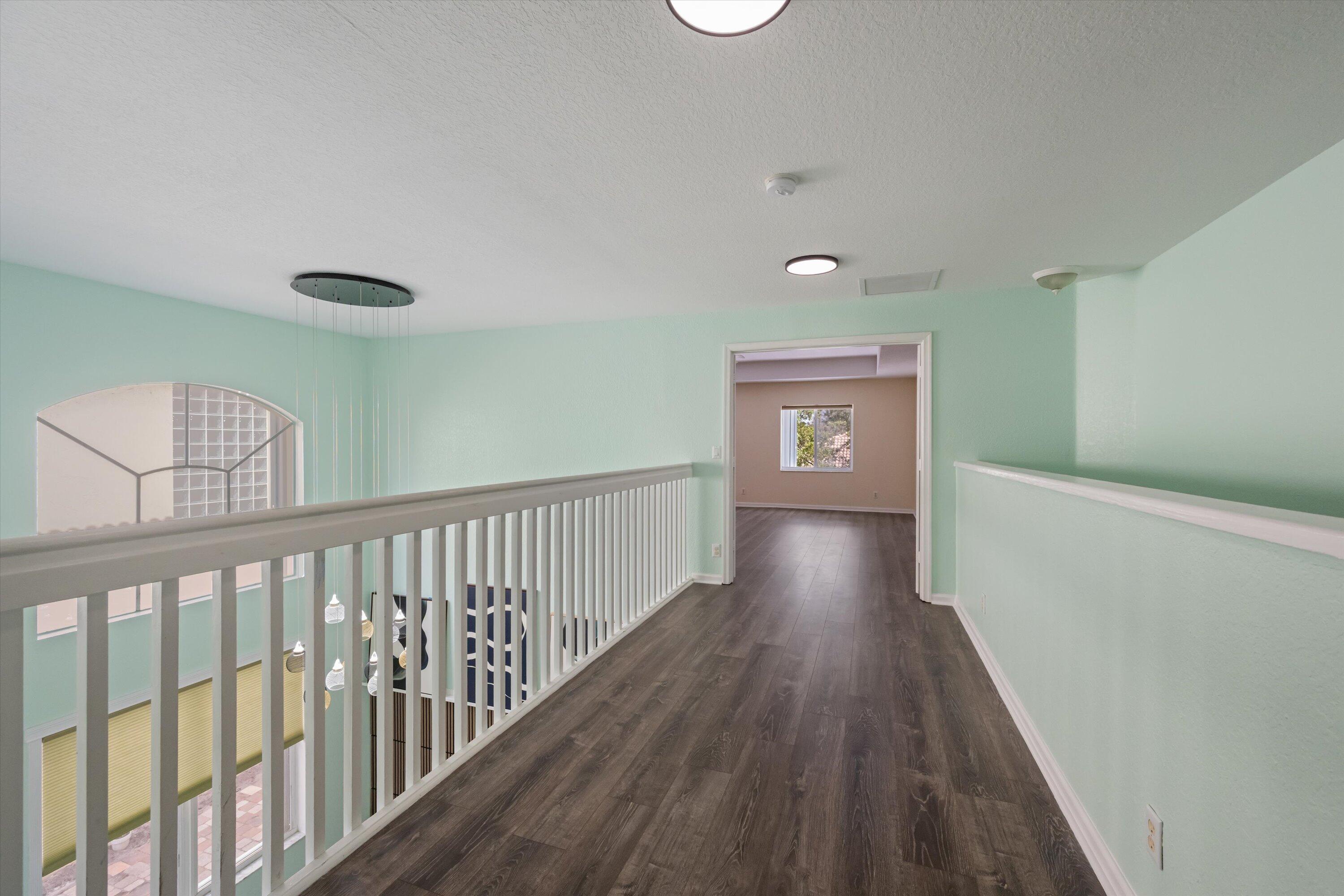 1222 Rose Gate Boulevard Riviera Beach, FL 33404 - Photo 14 of 29 a view of a hallway with wooden floor
