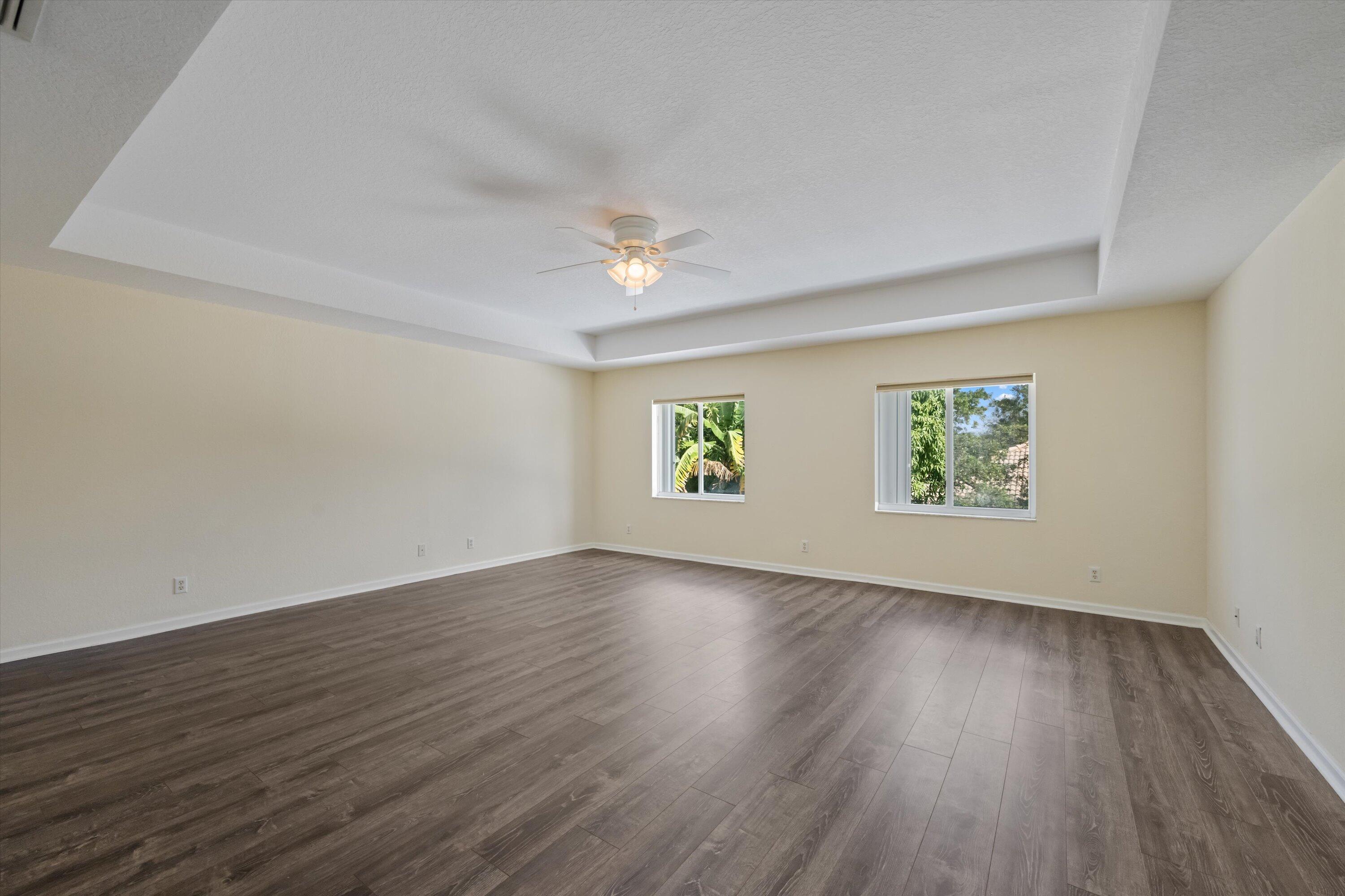 1222 Rose Gate Boulevard Riviera Beach, FL 33404 - Photo 15 of 29 an empty room with wooden floor and windows