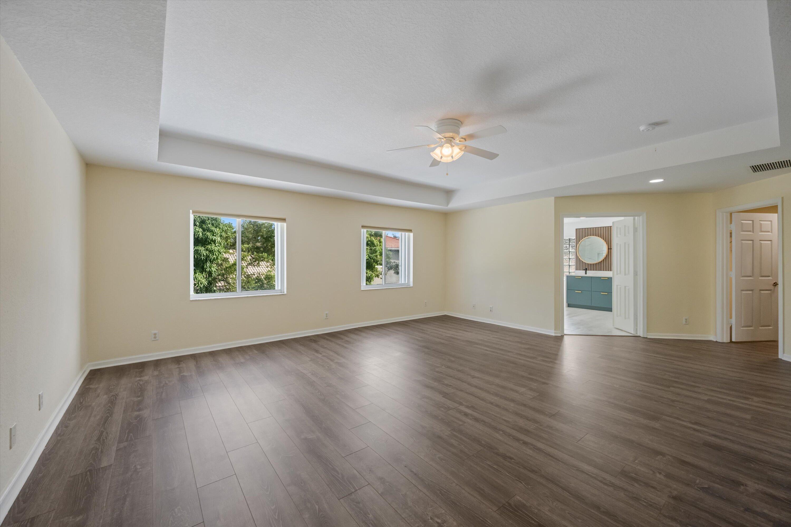 1222 Rose Gate Boulevard Riviera Beach, FL 33404 - Photo 16 of 29 an empty room with wooden floor and windows