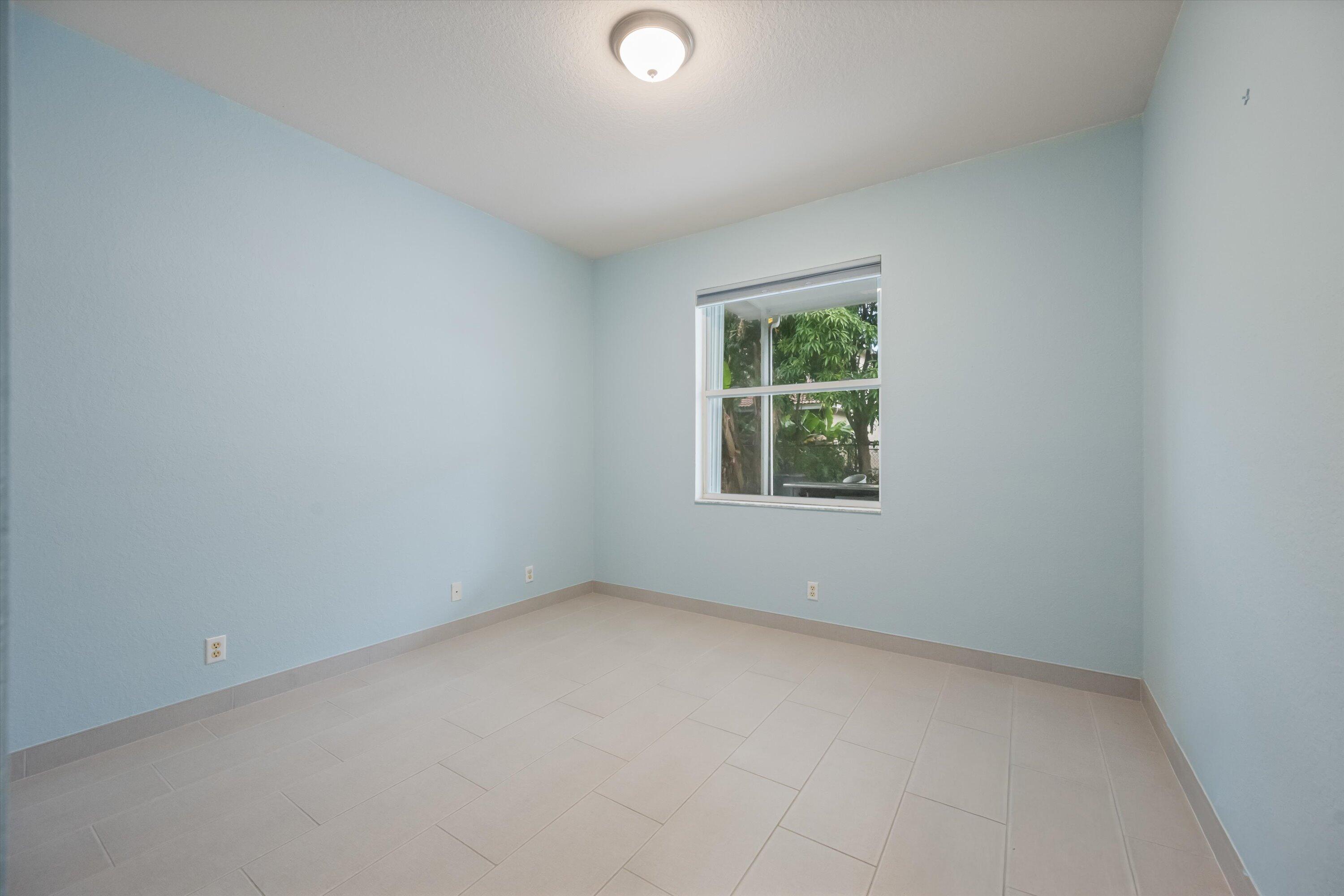 1222 Rose Gate Boulevard Riviera Beach, FL 33404 - Photo 18 of 29 an empty room with windows