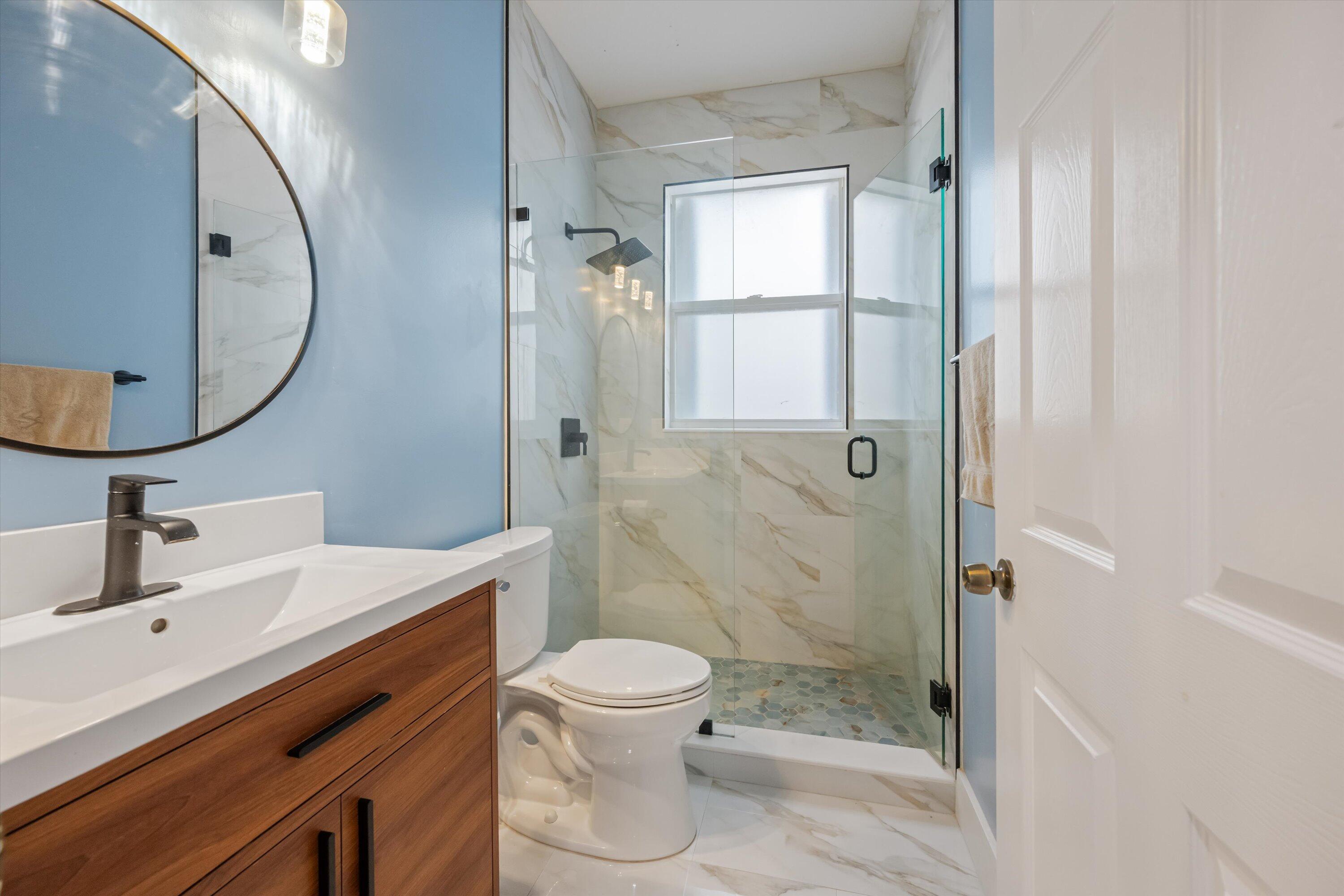 1222 Rose Gate Boulevard Riviera Beach, FL 33404 - Photo 19 of 29 a bathroom with a sink a toilet and shower