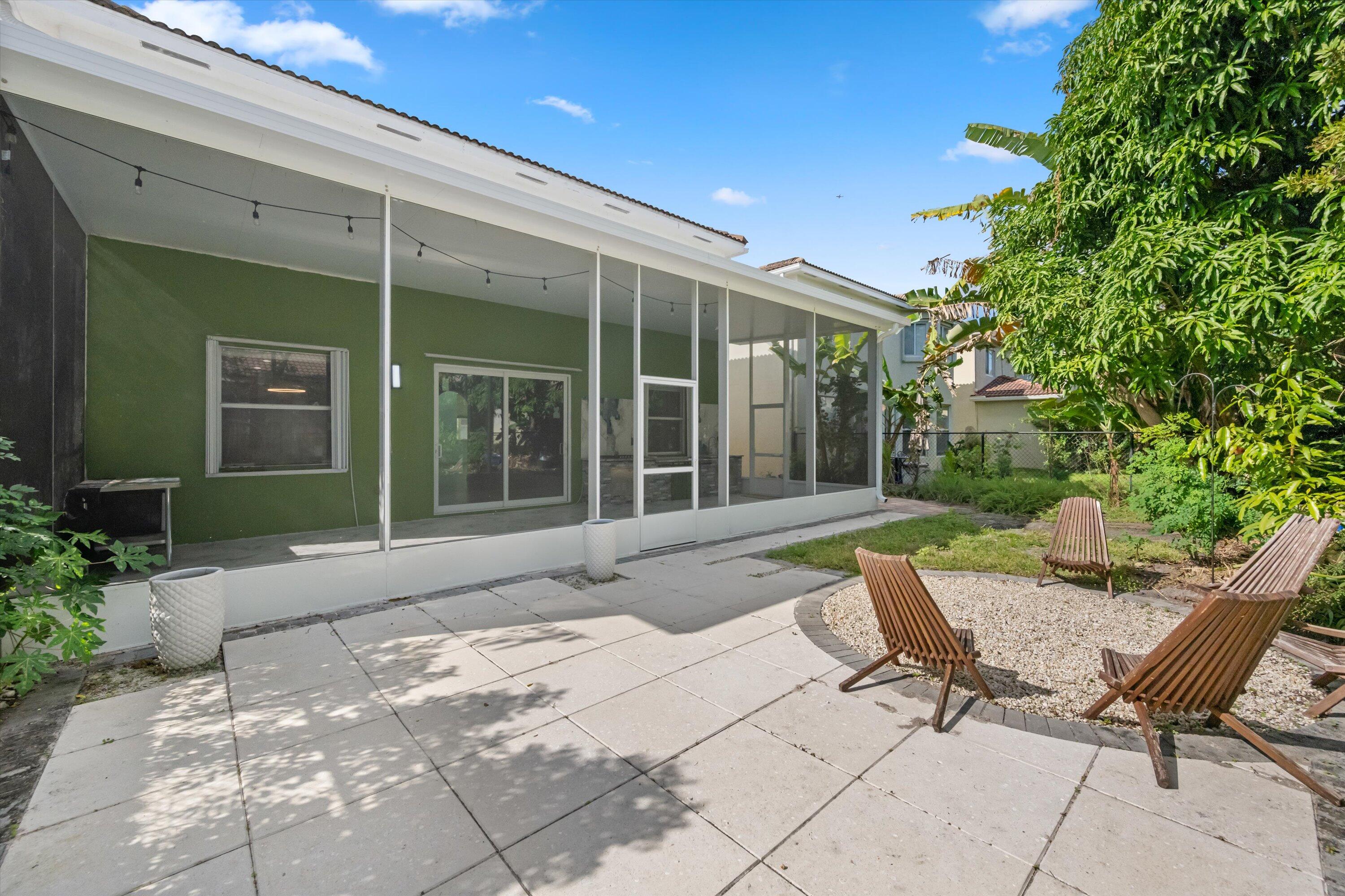 1222 Rose Gate Boulevard Riviera Beach, FL 33404 - Photo 27 of 29 a view of a lounge chair in the patio of a house