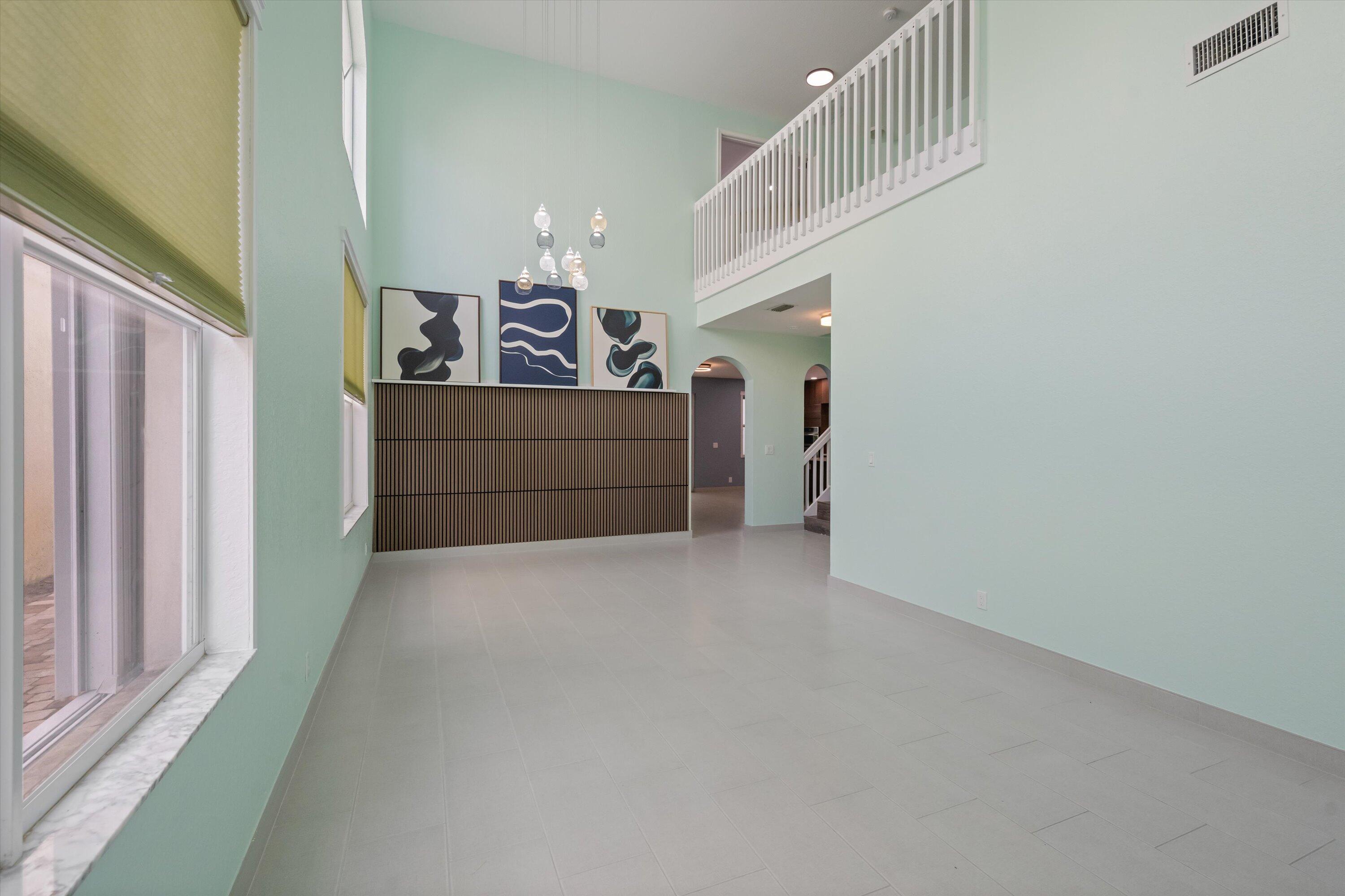 1222 Rose Gate Boulevard Riviera Beach, FL 33404 - Photo 5 of 29 a view of a hallway with stairs and furniture