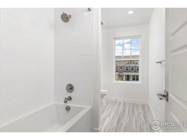 a bathroom with a bathtub and shower
