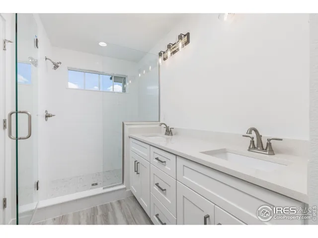 a bathroom with a shower sink and mirror
