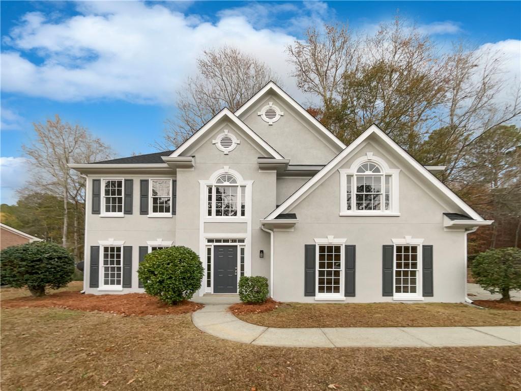 a front view of a house with a yard