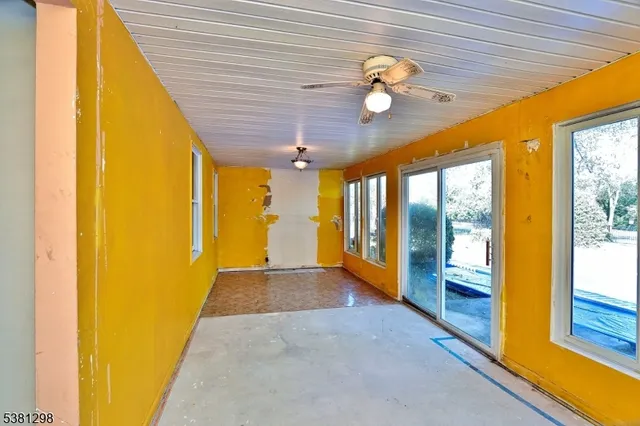 a view of a livingroom with a ceiling fan and window
