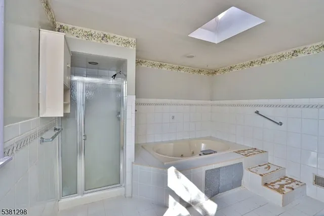 a bathroom with a bathtub and shower
