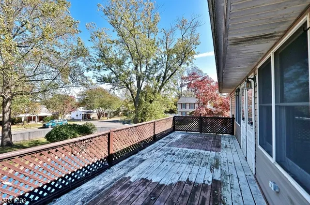 a view of balcony with wooden floor and fence