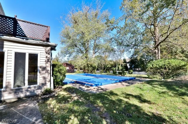 a view of swimming pool with a house