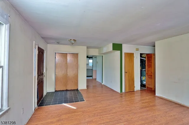 a view of a hallway with wooden shelves