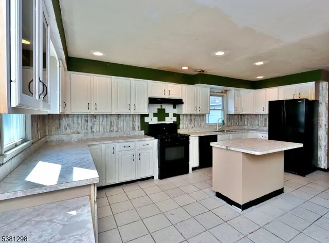 a kitchen with a sink cabinets and stainless steel appliances