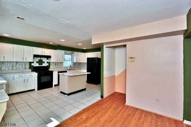 a kitchen with a refrigerator and a stove top oven