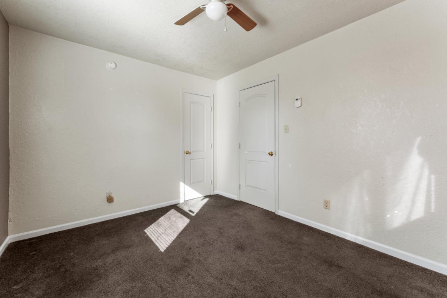 5192 Chestnut Road Olivehurst, CA 95961 - Photo 16 of 24 an empty room with ceiling fan and window