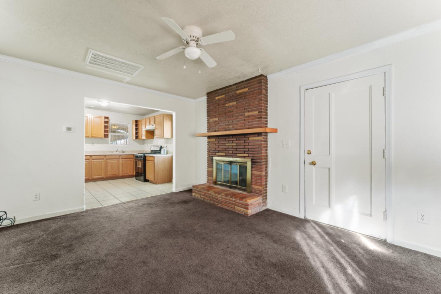 5192 Chestnut Road Olivehurst, CA 95961 - Photo 5 of 24 a view of a livingroom with a fireplace a sink and dishwasher kitchen view
