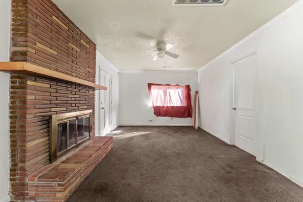 a view of empty room with fireplace