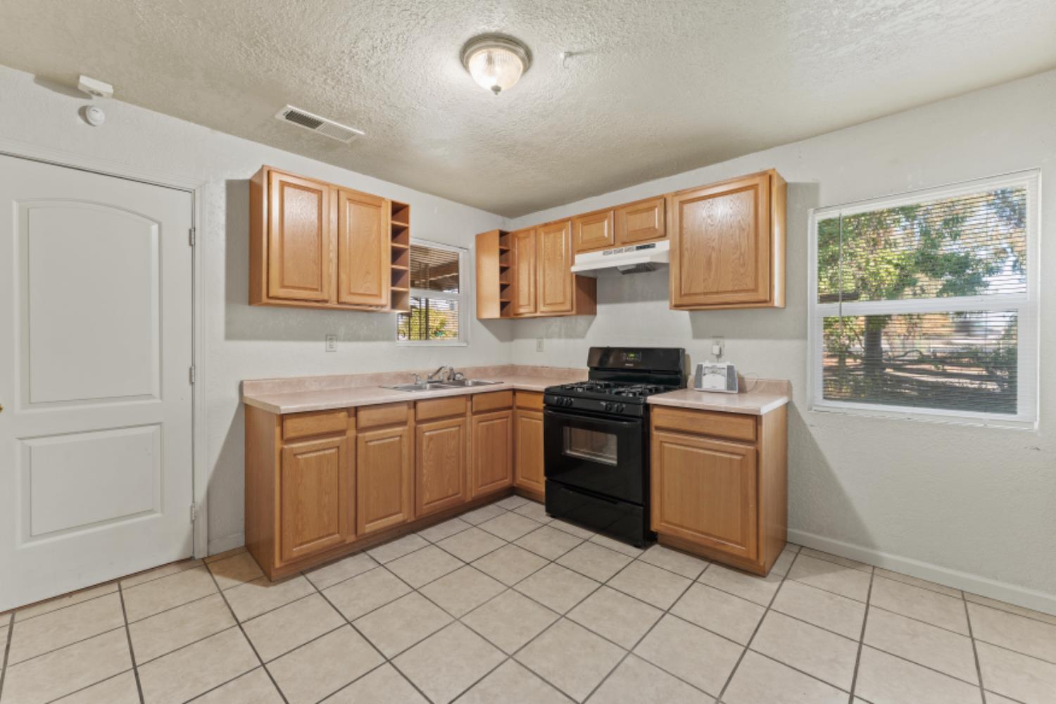 5192 Chestnut Road Olivehurst, CA 95961 - Photo 9 of 24 a kitchen with granite countertop a sink and a stove top oven