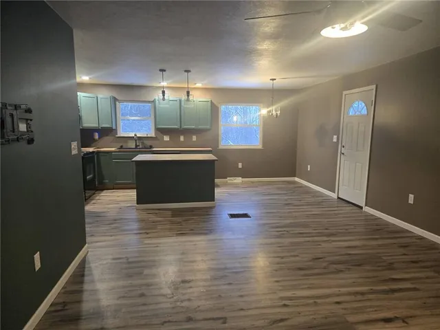 a view of kitchen with sink and refrigerator