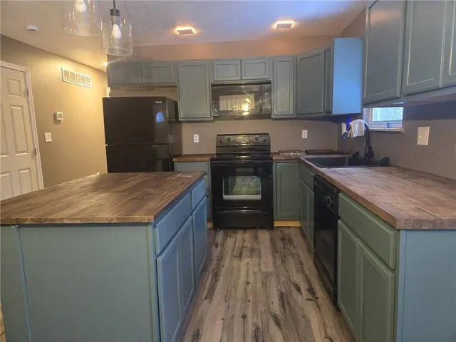 a kitchen with a sink stove and refrigerator