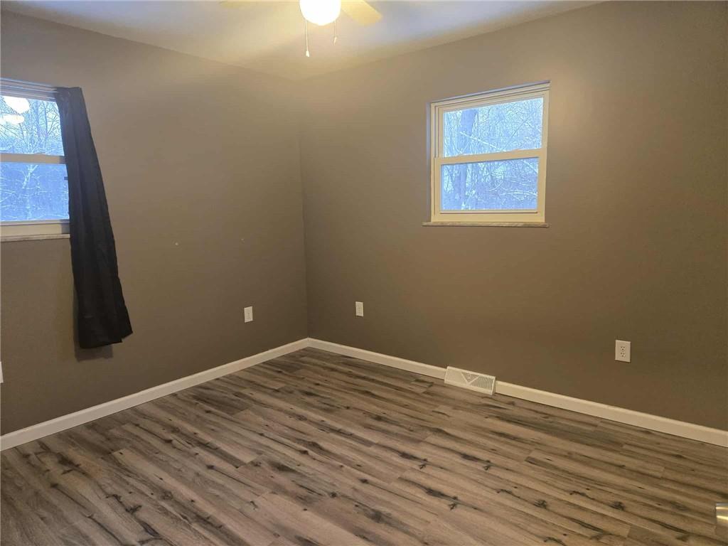504 Queenstown Road Karns City, PA 16041 - Photo 8 of 18 a view of an empty room with wooden floor and a window