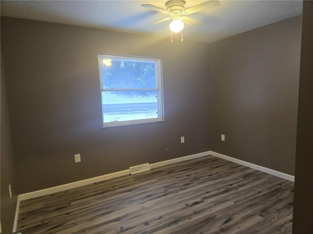 504 Queenstown Road Karns City, PA 16041 - Photo 10 of 18 a view of a room with wooden floor and fan
