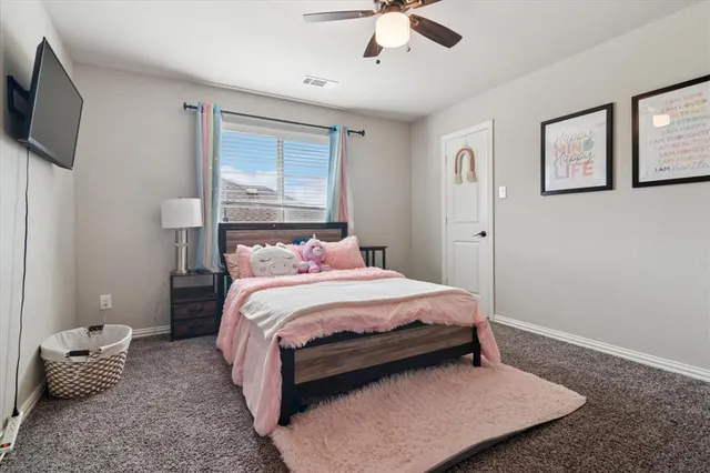a bedroom with a bed window and couch