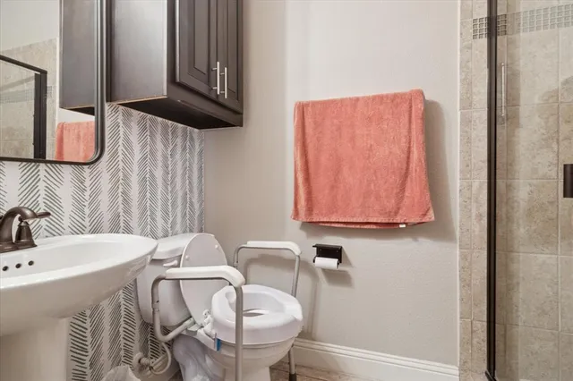 a bathroom with a sink a mirror and a toilet