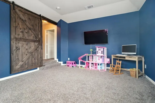 a view of game room with windows