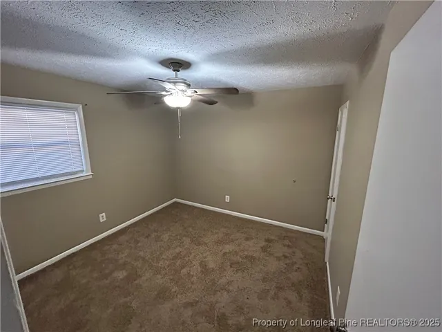 en view of empty room with fan