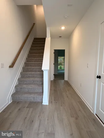 a view of entryway and hall with wooden floor