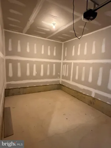 a view of a big room with wooden floor and windows