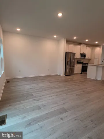 a kitchen with granite countertop a refrigerator and a sink