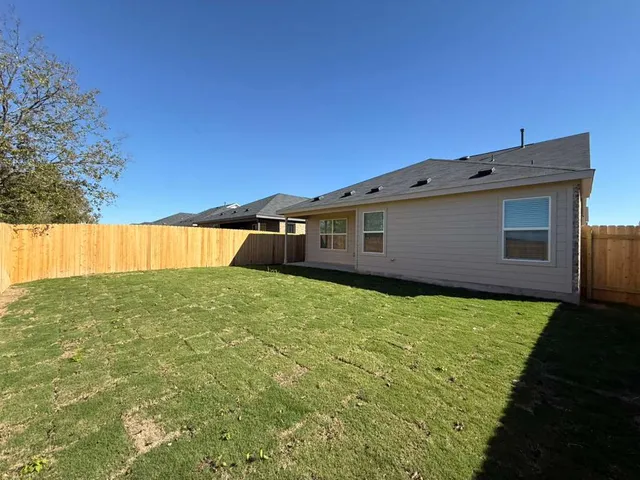 a front view of a house with a yard table and chairs
