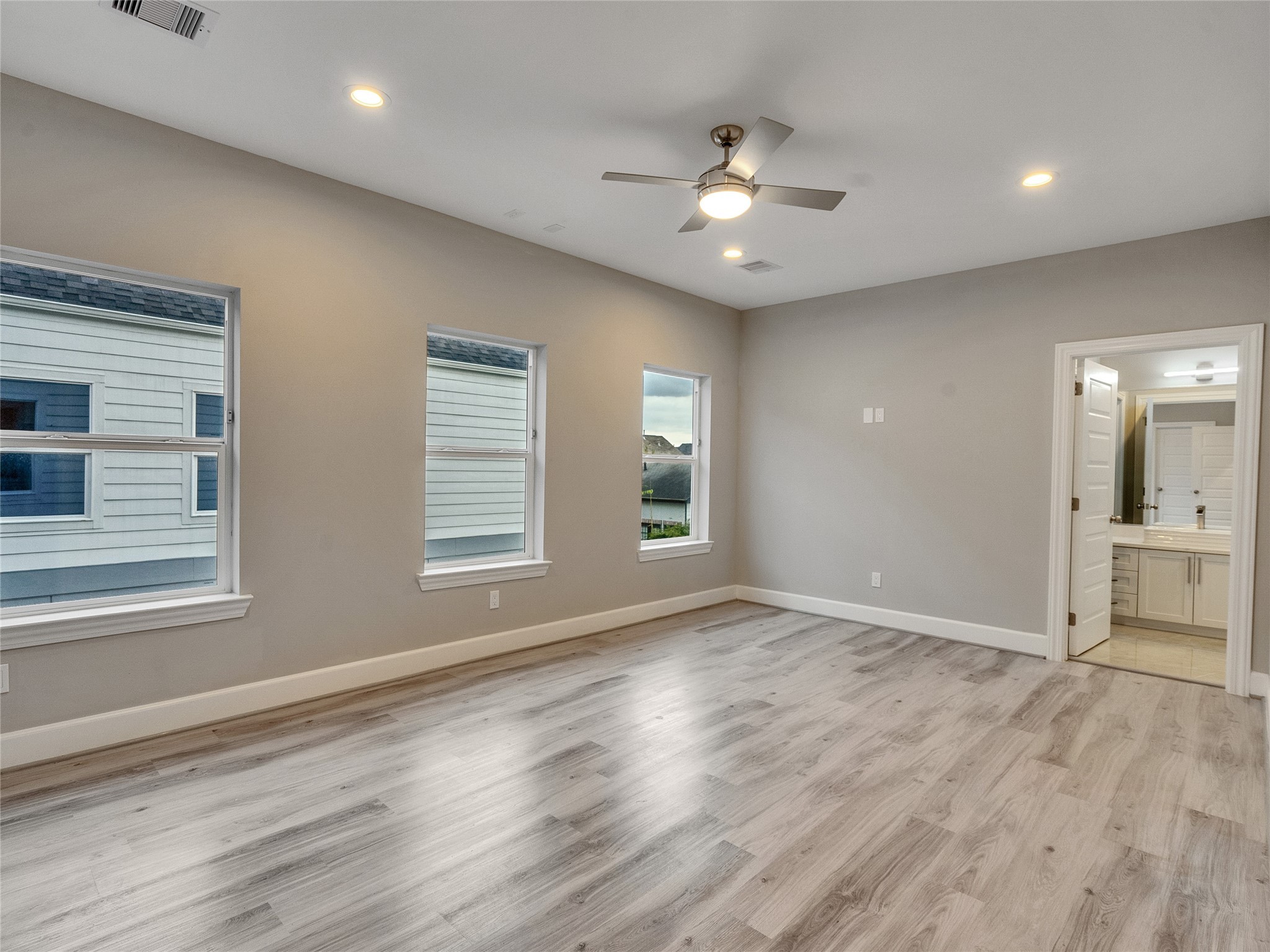 1122 West 16th Street, Unit D Houston, TX 77008 - Photo 30 of 40 a view of an empty room with a window and wooden floor